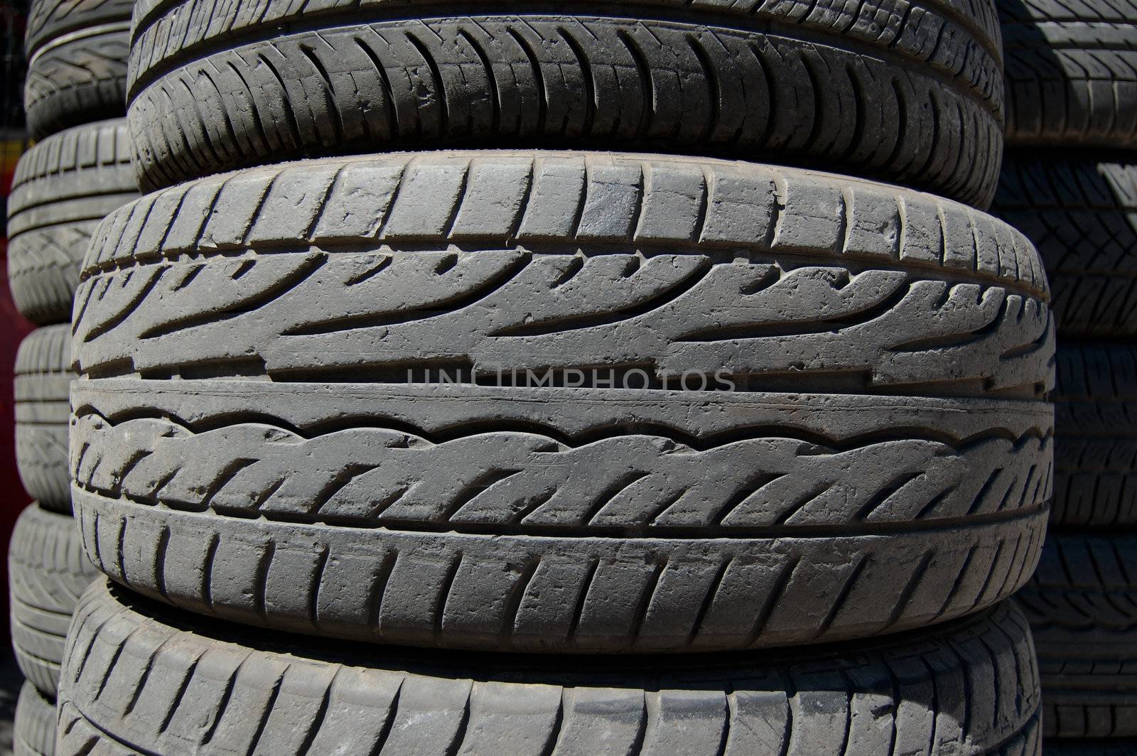 Pile of used rubber car tires. Abstract background.