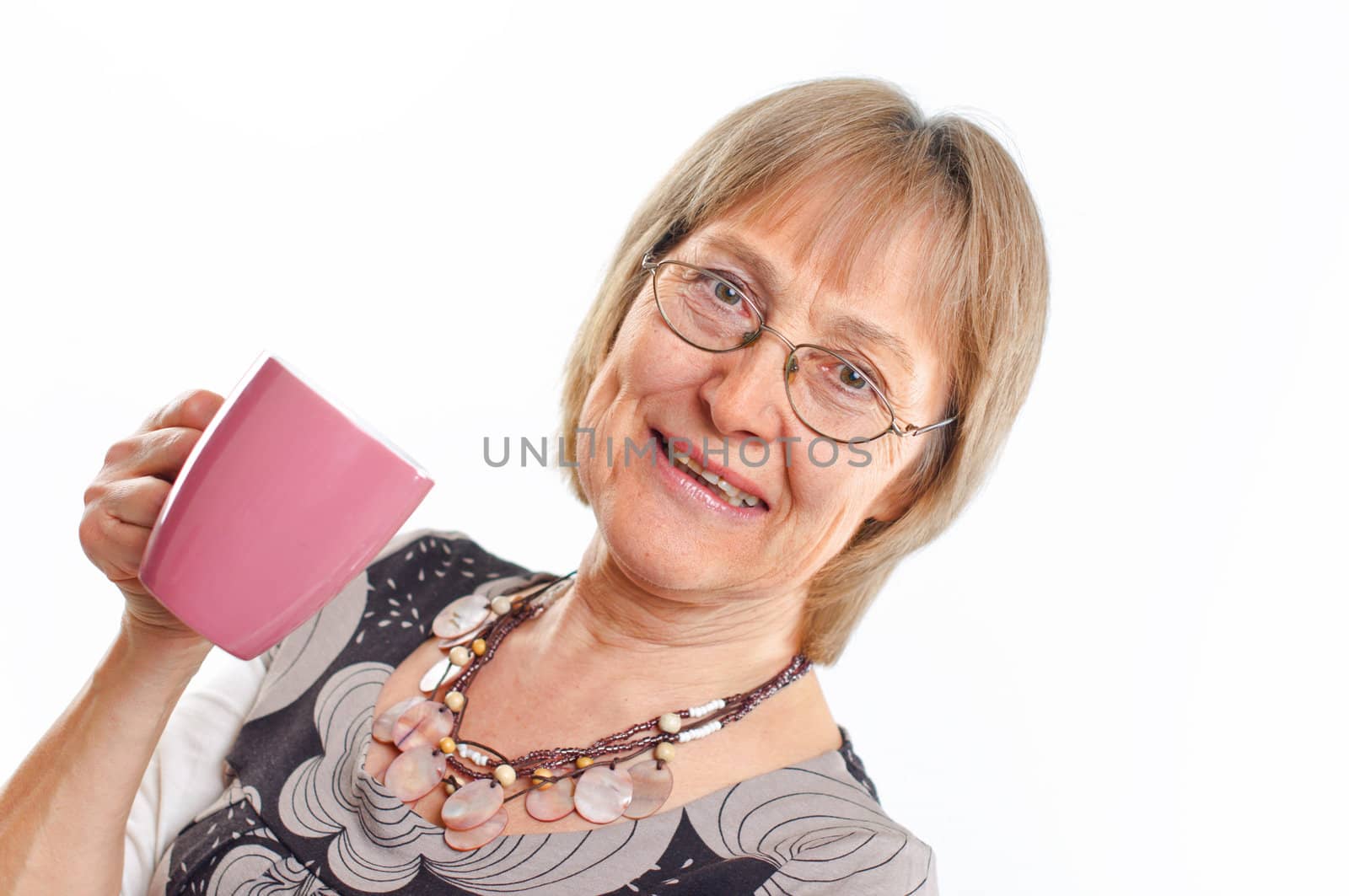 Portrait of a happy aged woman smiling with cup