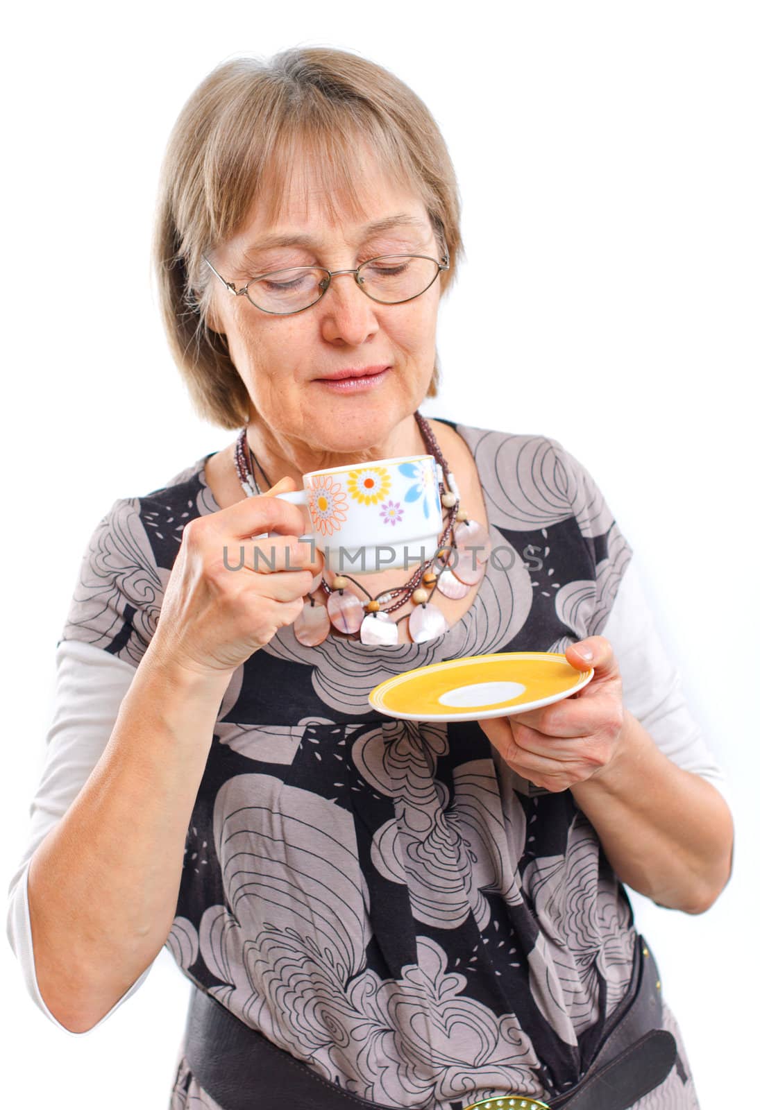 Portrait of a happy aged woman smiling with cup