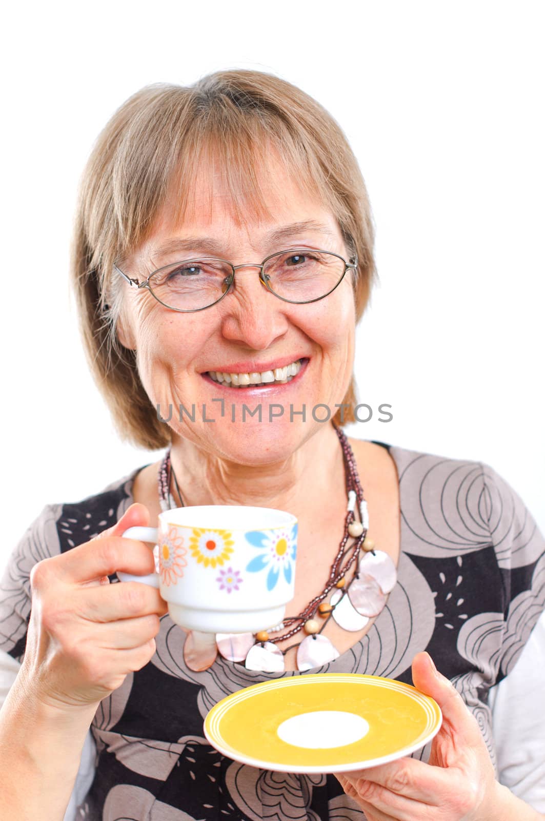 Portrait of a happy aged woman smiling with cup