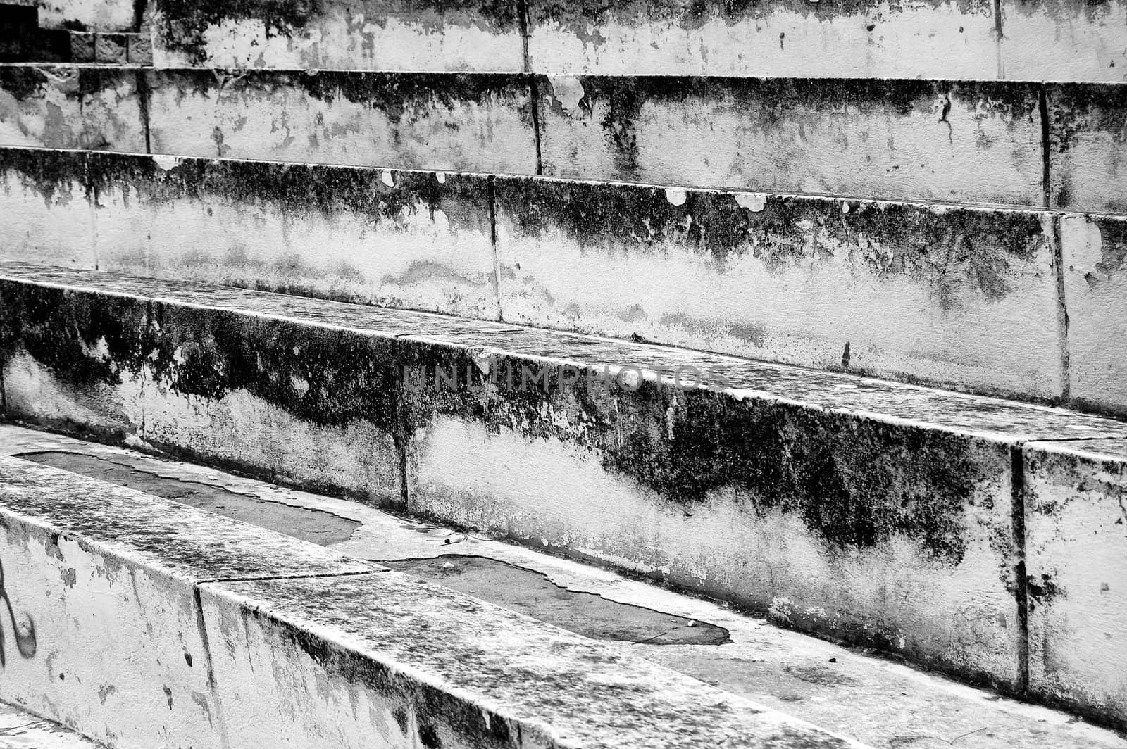 Weathered amphitheatre stone steps. Black and white.