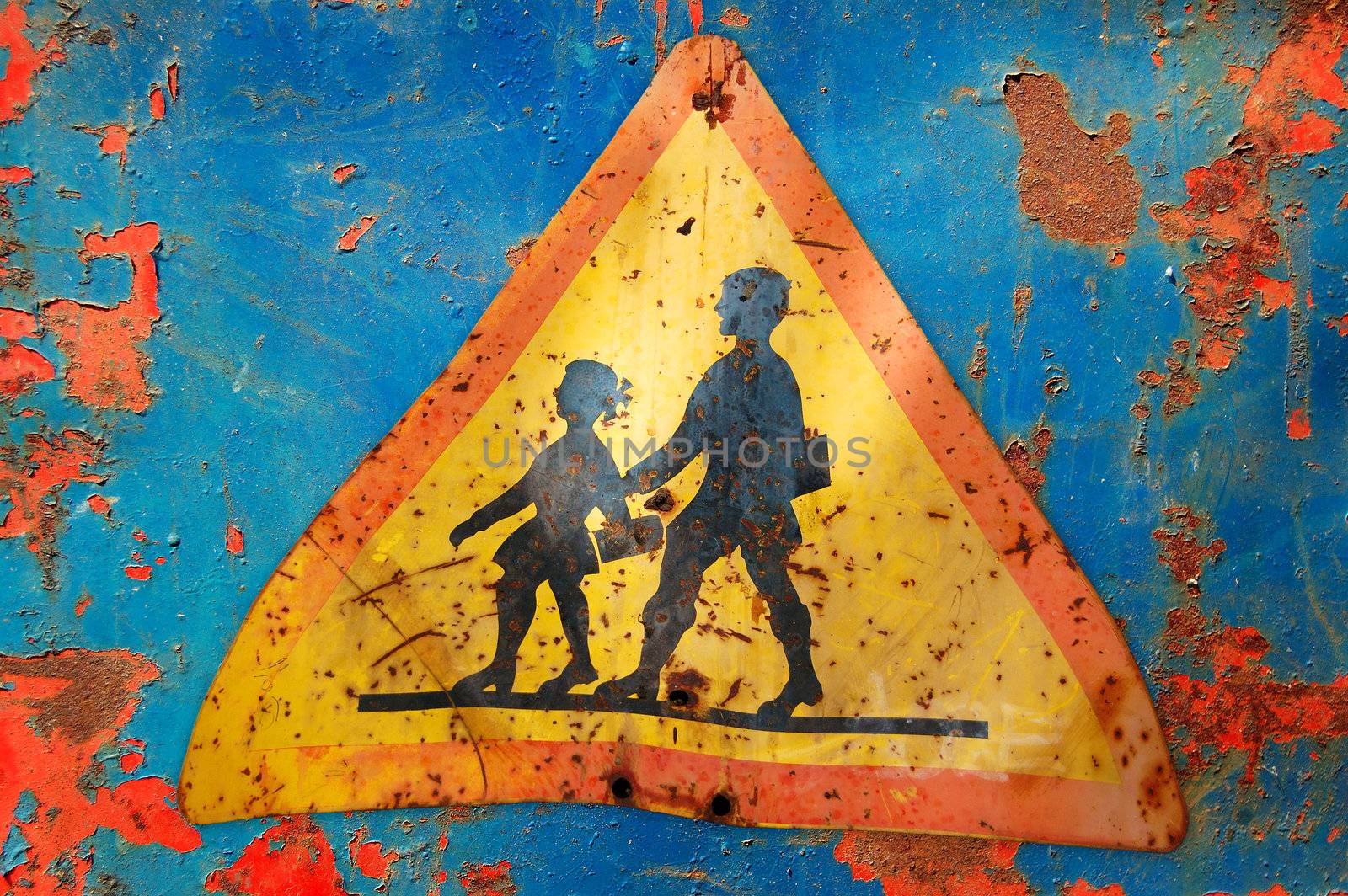 Rusty traffic control warning sign for school children. Speed restriction.