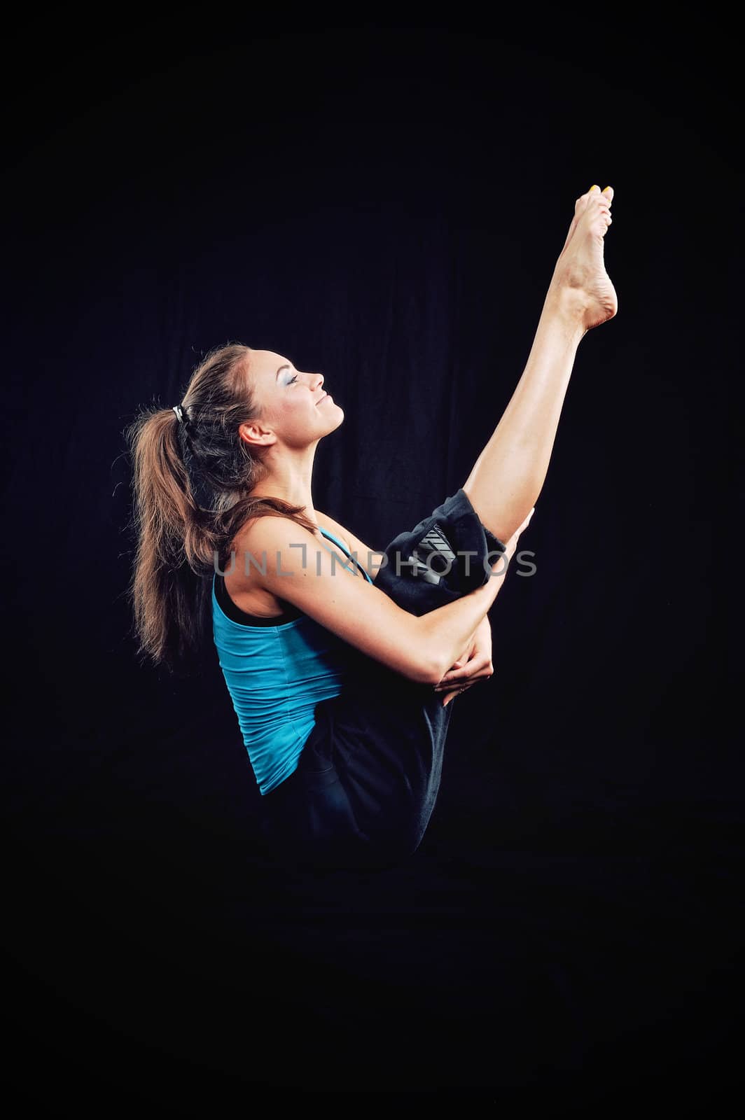 Young woman in tracksuit do yoga exercise