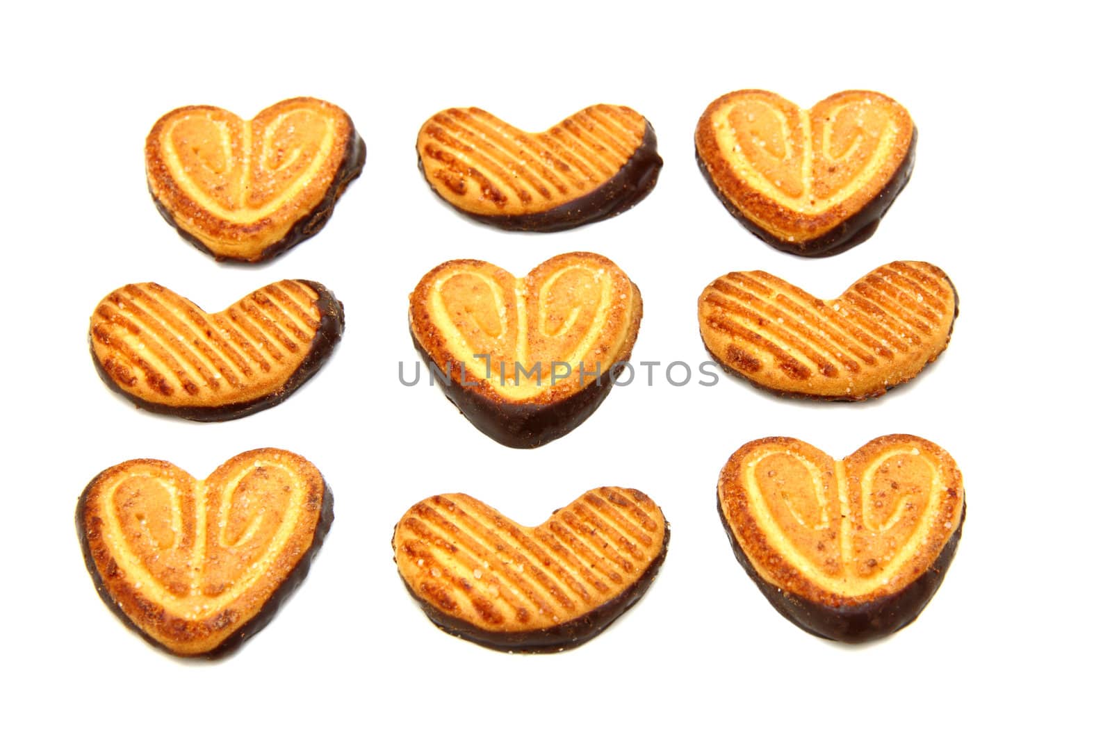 Cookies in the form of heart with chocolate on a white background