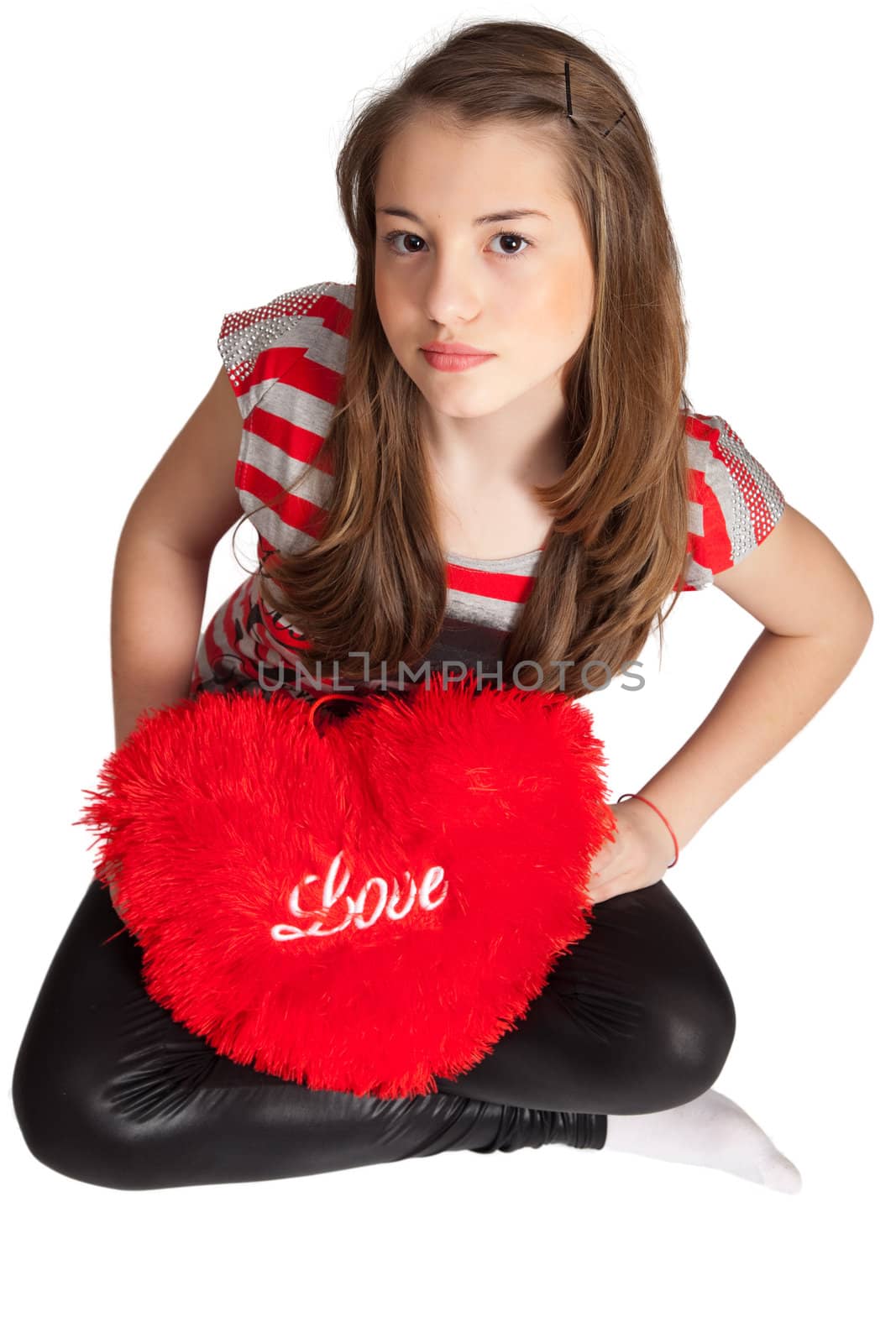 Beautiful Girl Sitting With Heart Shaped Red Pillow isolated on white background.