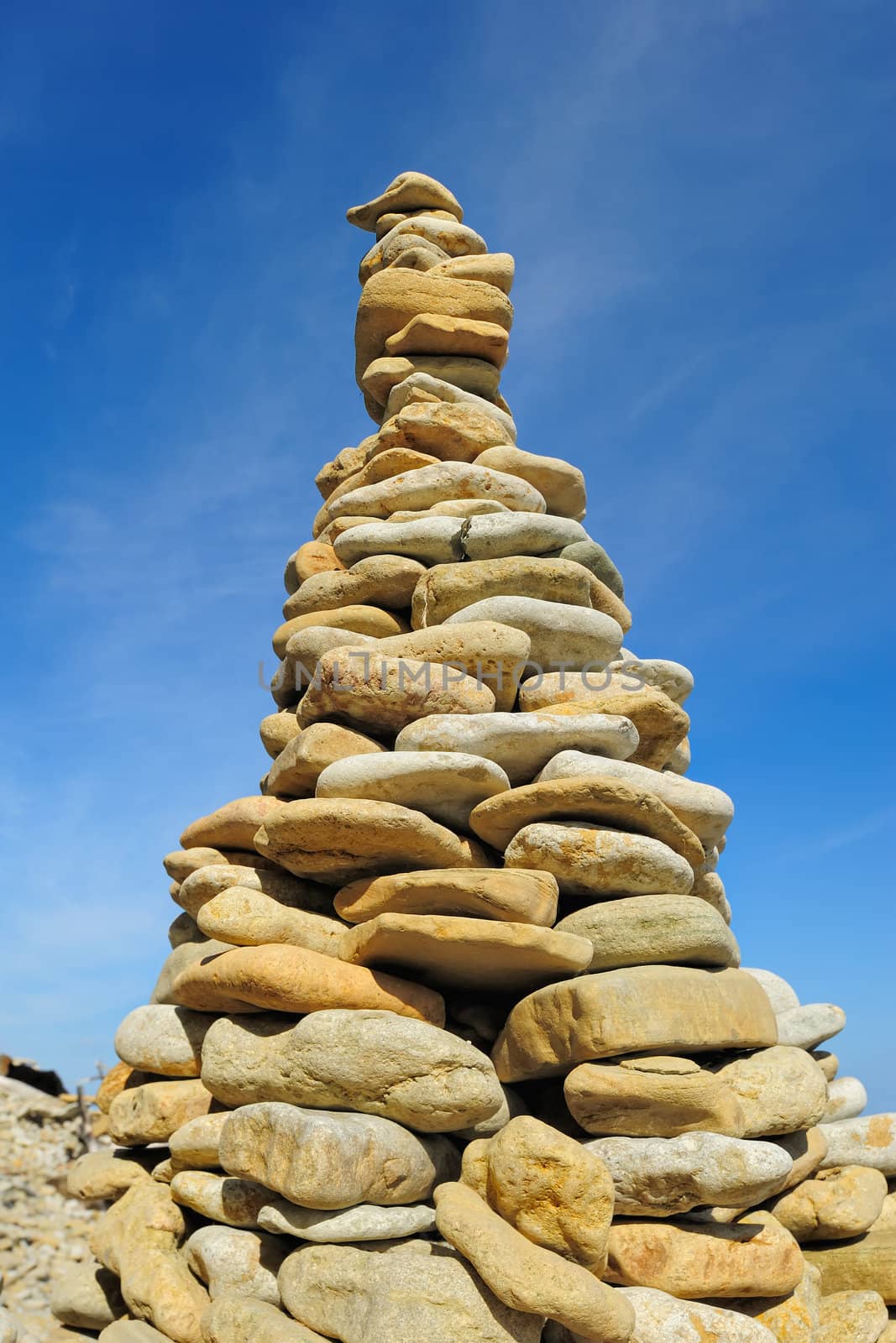 Pile of pebble as the tower against the background of sky