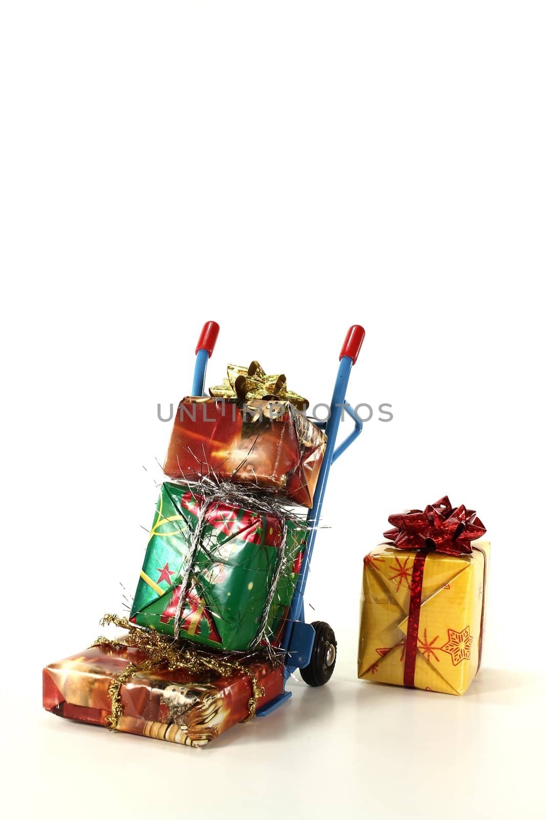 many colorful Christmas presents on a hand truck