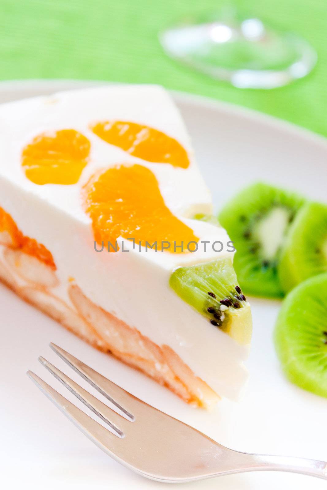 A delicious cake with clementine and kiwi on a bed of biscuits