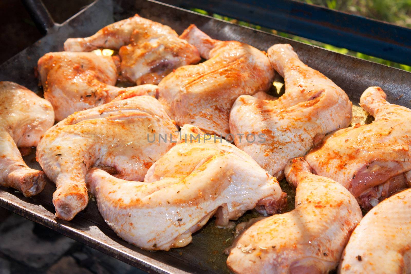 Chicken with honey and spices, cooking on a wood fire