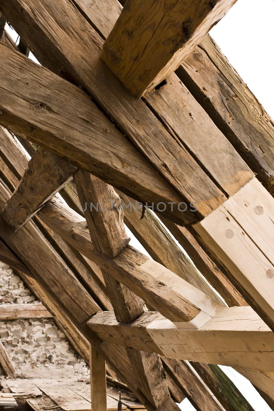 wooden framework on ancient roof with old and new wood