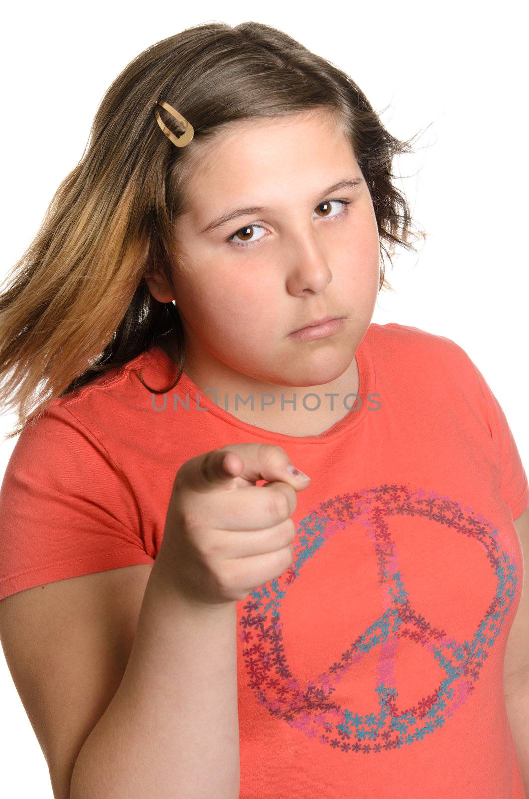 A young preteen girl giving the viewer heck or discipline for something, isolated against a white background.