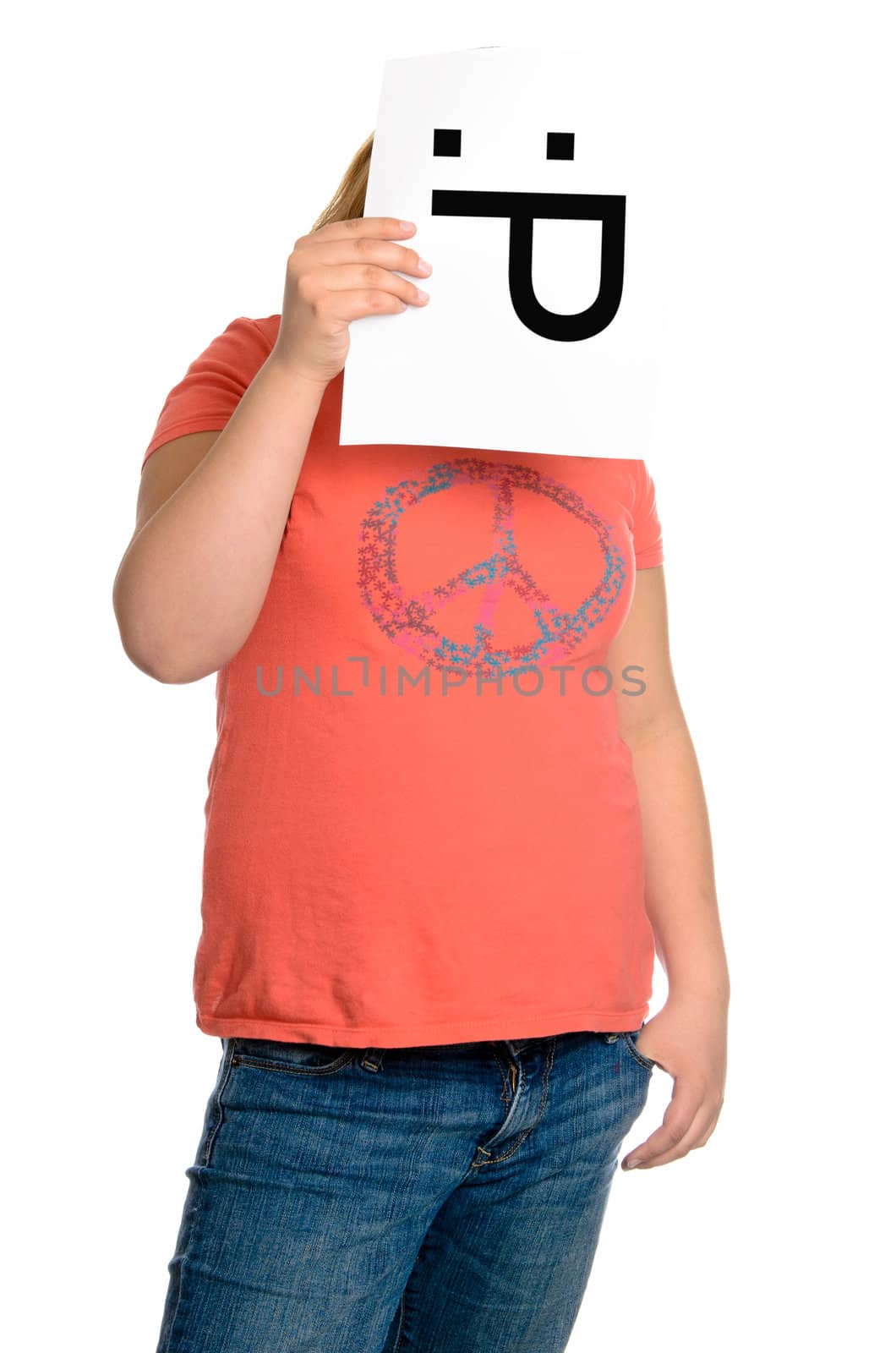 A young girl holding up an emoticon face with two eyes and a tongue sticking out, isolated against a white background.