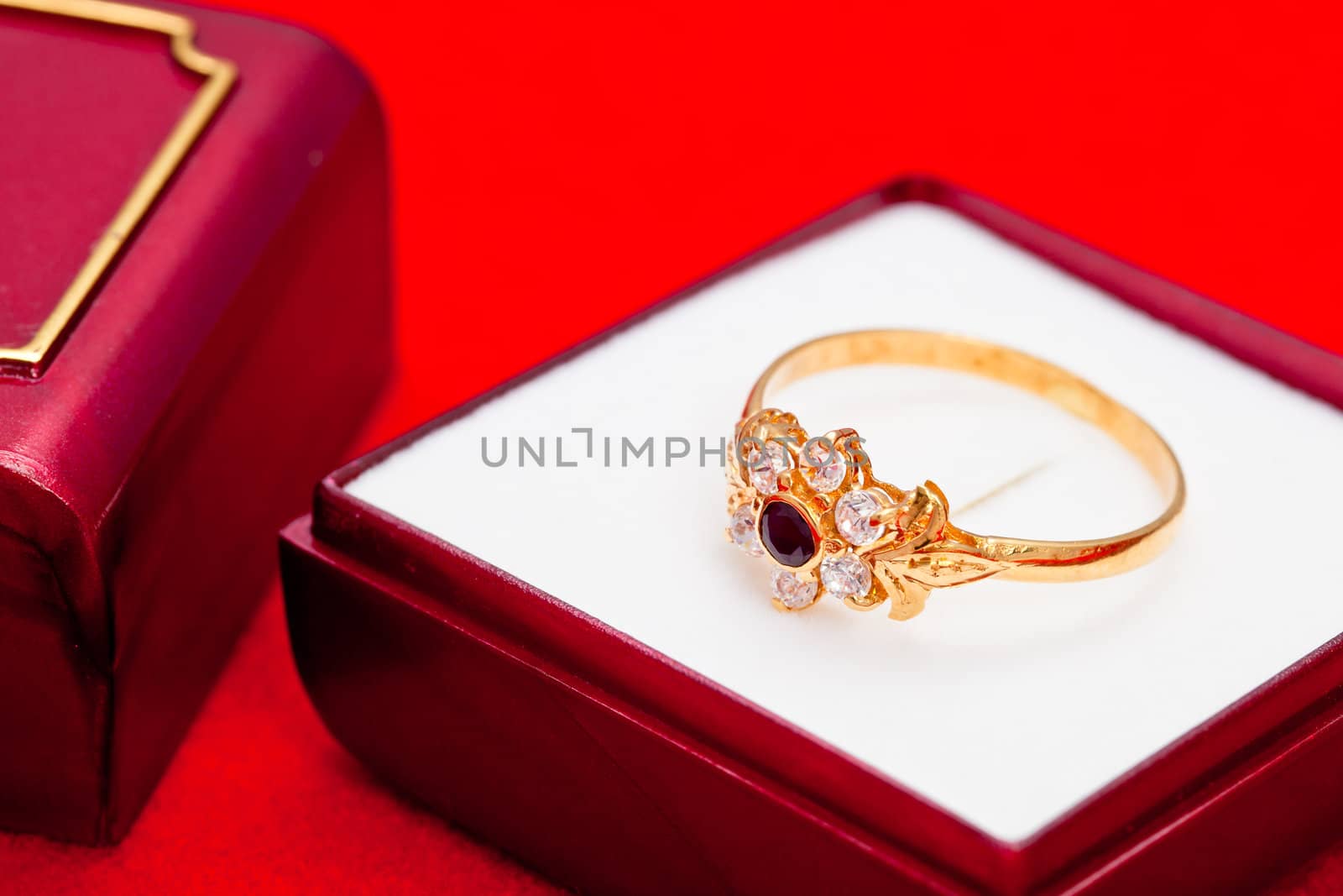 Fantastic gold ring adorned with one blue  and several white zirconia