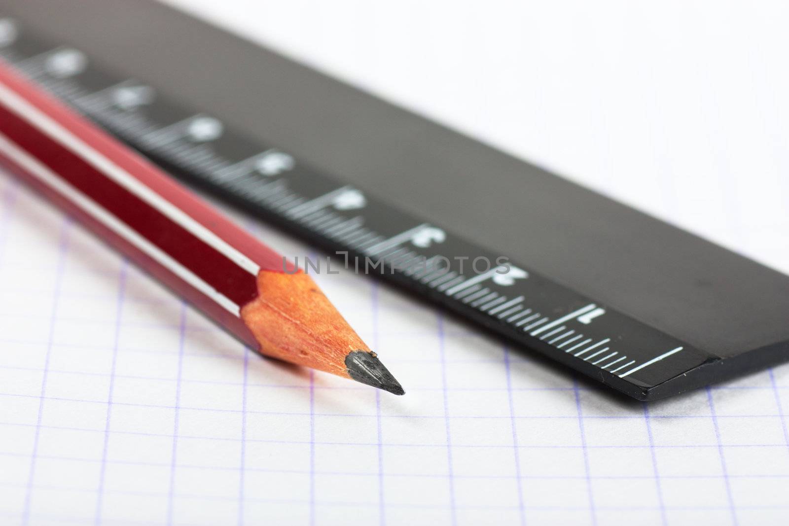 Macro view of pencil and ruler on exercise book page