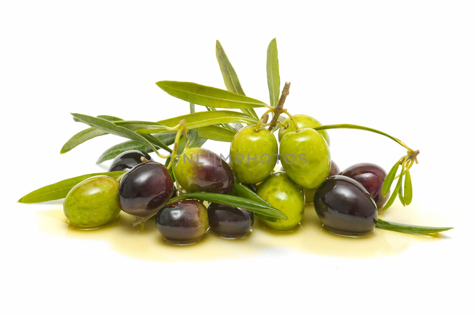 variety of fresh olives with olive oil on white background
