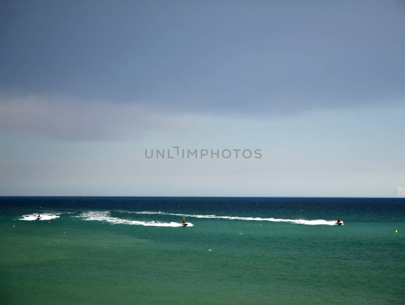 Three watercraft in a sea of bright colors
