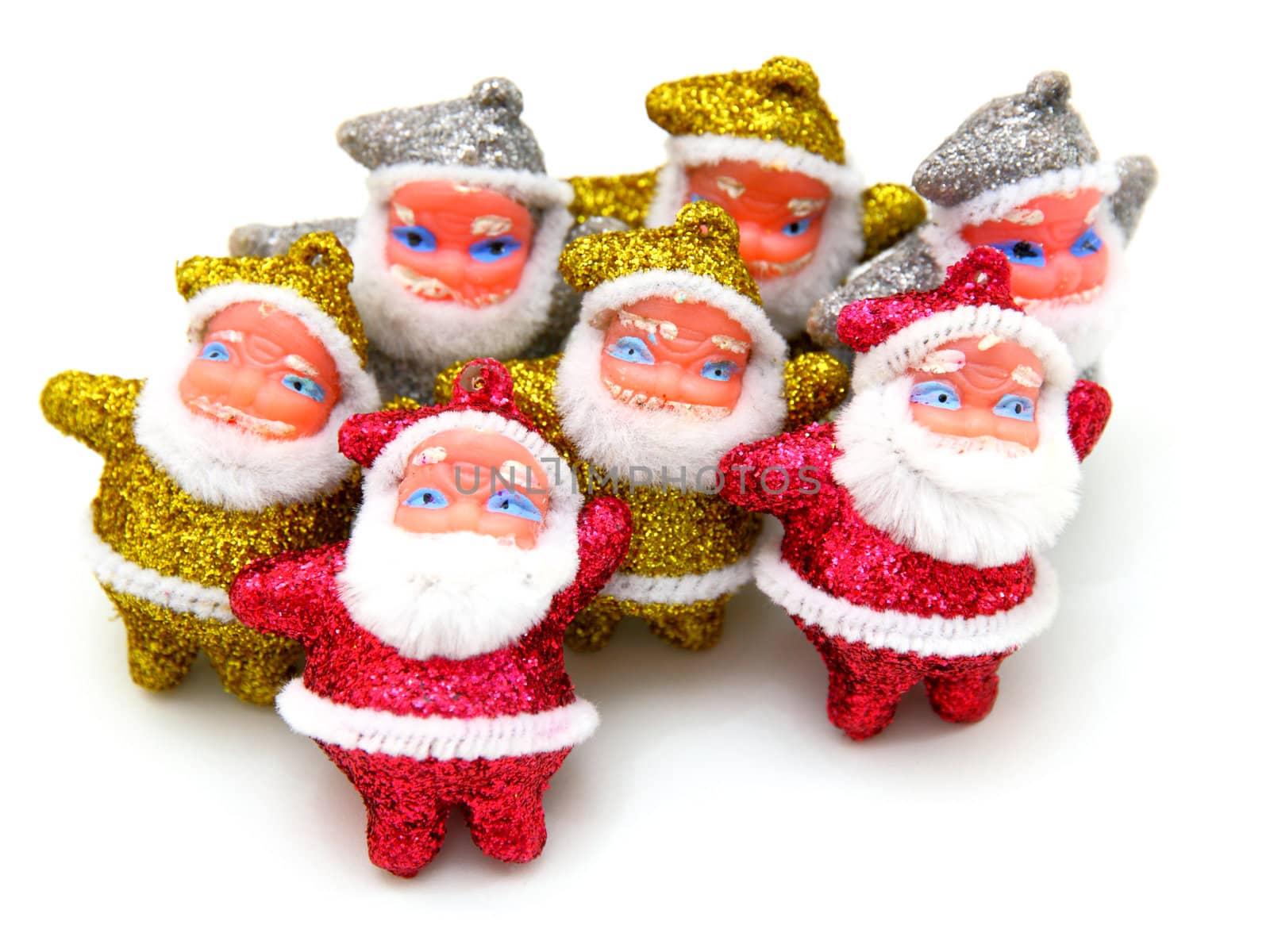 Some dolls of Santa Claus are together isolated on a white background