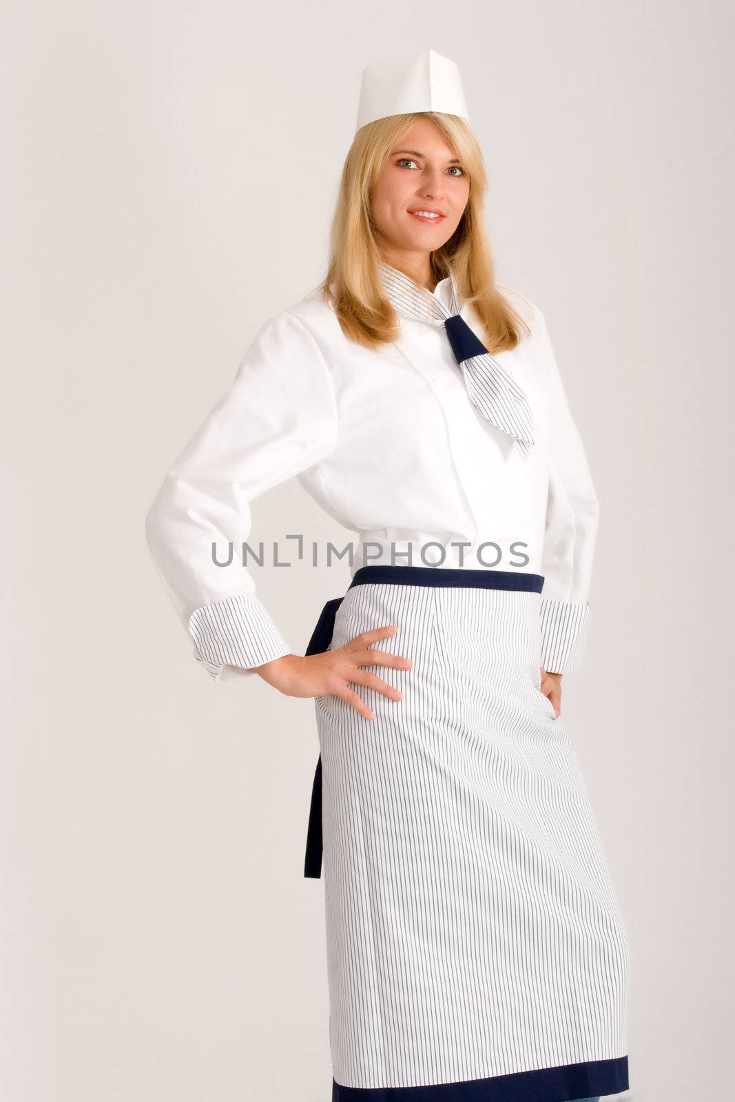 Blonde cook in fashionable work wear with a hat