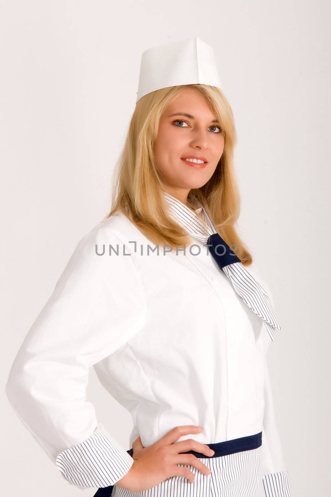 Blonde cook in fashionable work wear with a hat