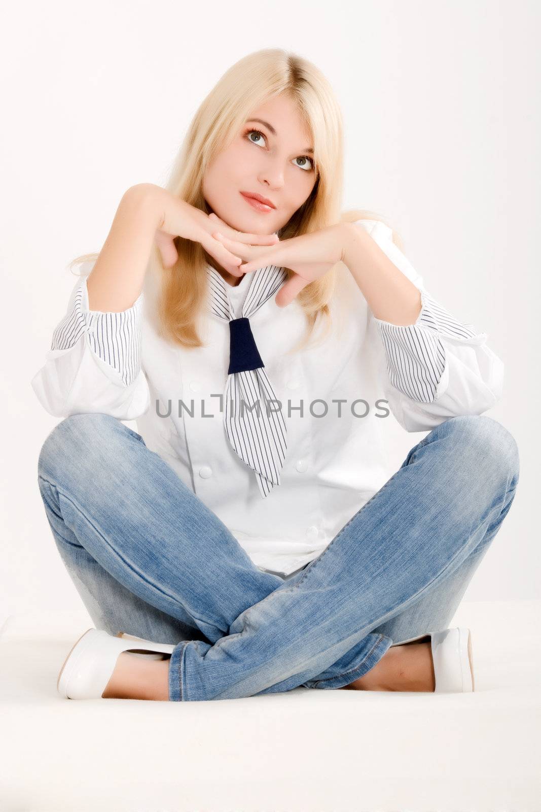 Positive-thinking woman in work clothes sitting on the floor