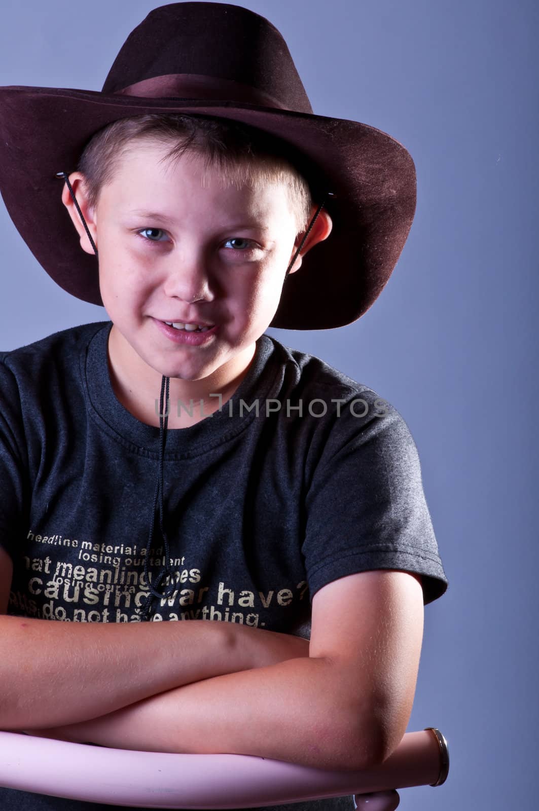 Young boy. Portrait in studio on a grey background.