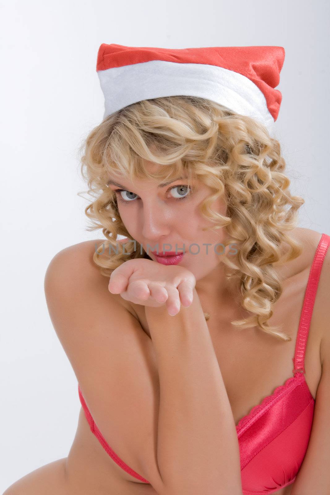 sexy woman in red lingerie and santa hat distributed kisses