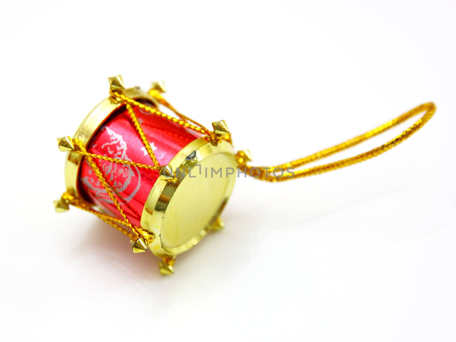 red toy as drum against the white background