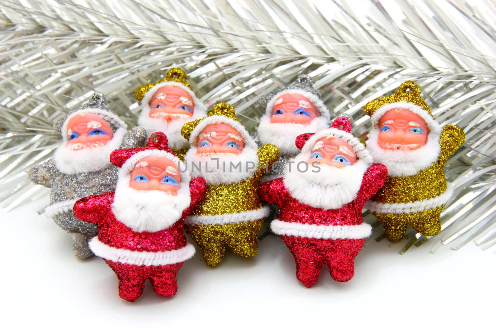 Some dolls of Santa Claus are together isolated on a white background