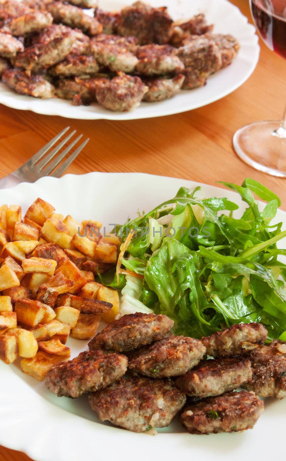 Meatballs with beef and spices, fries potatoes and salad 