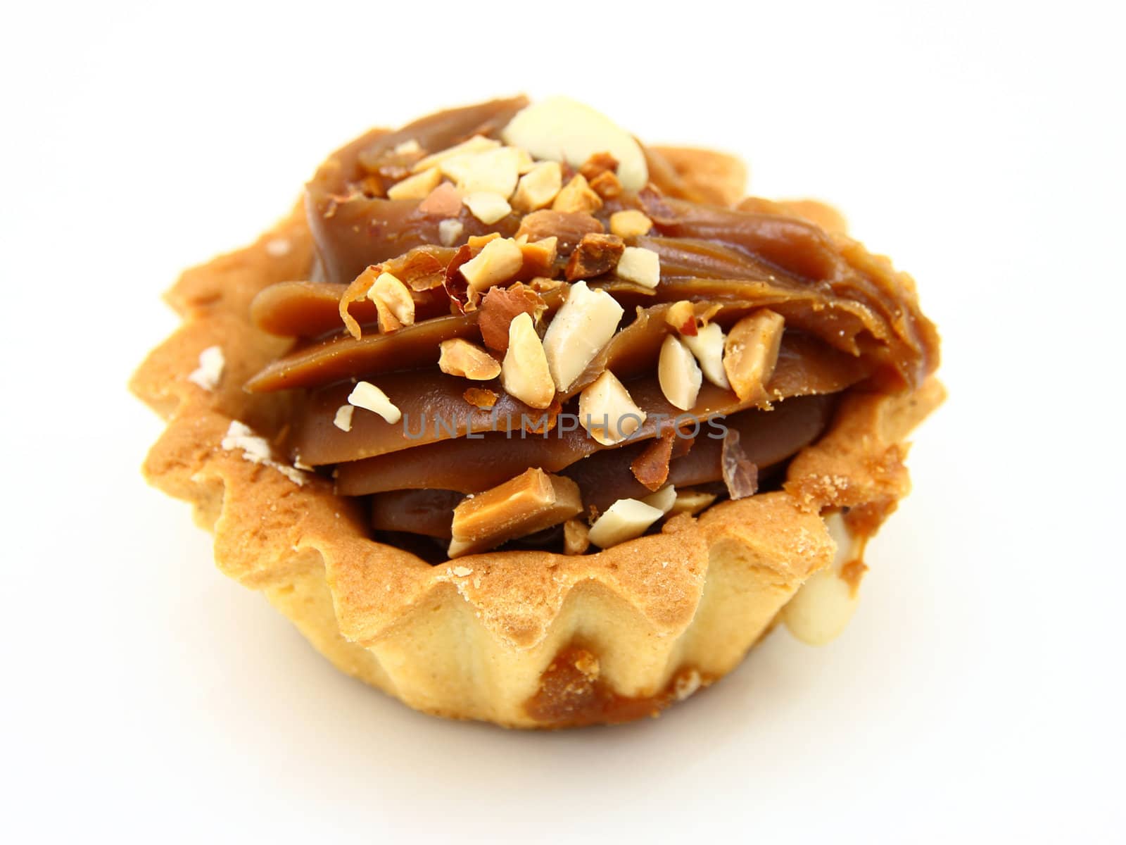 Pie a basket with chocolate condensed milk and nuts on a white background