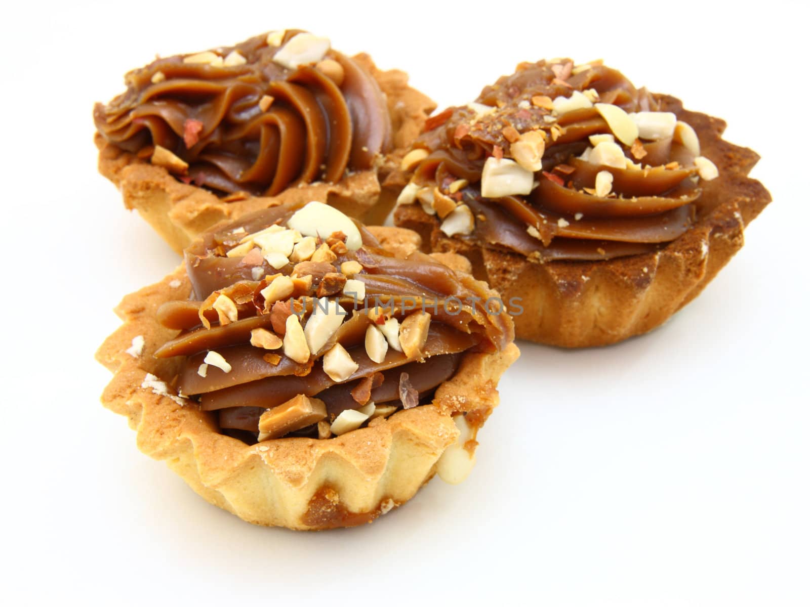 Pie a basket with chocolate condensed milk and nuts on a white background