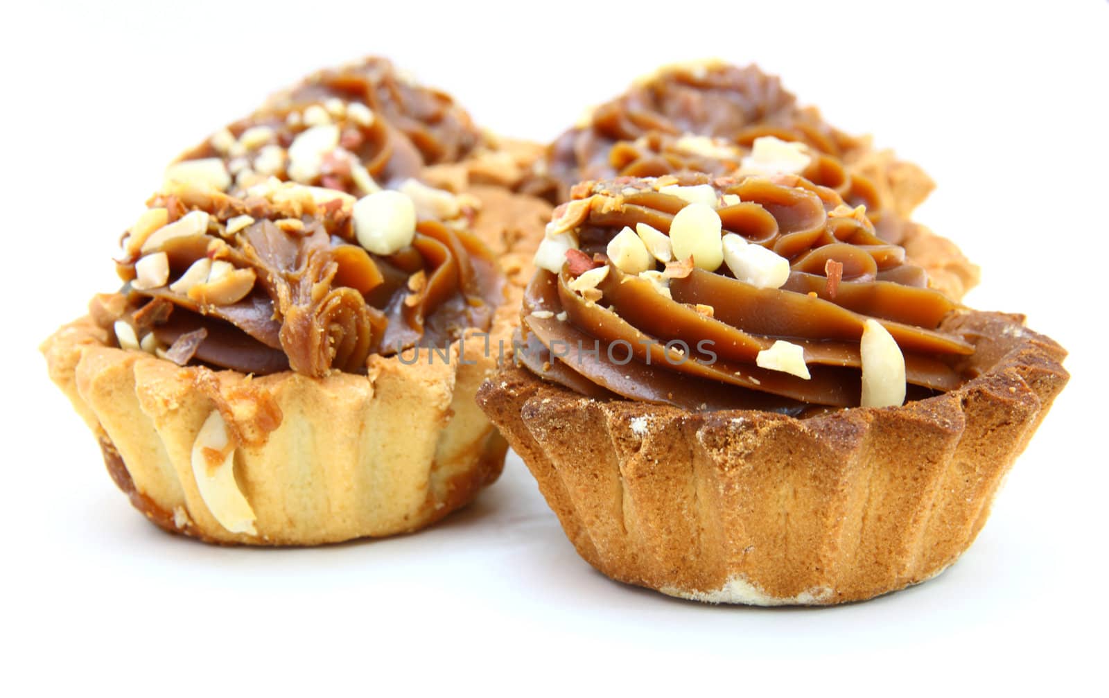 Pie a basket with chocolate condensed milk and nuts on a white background