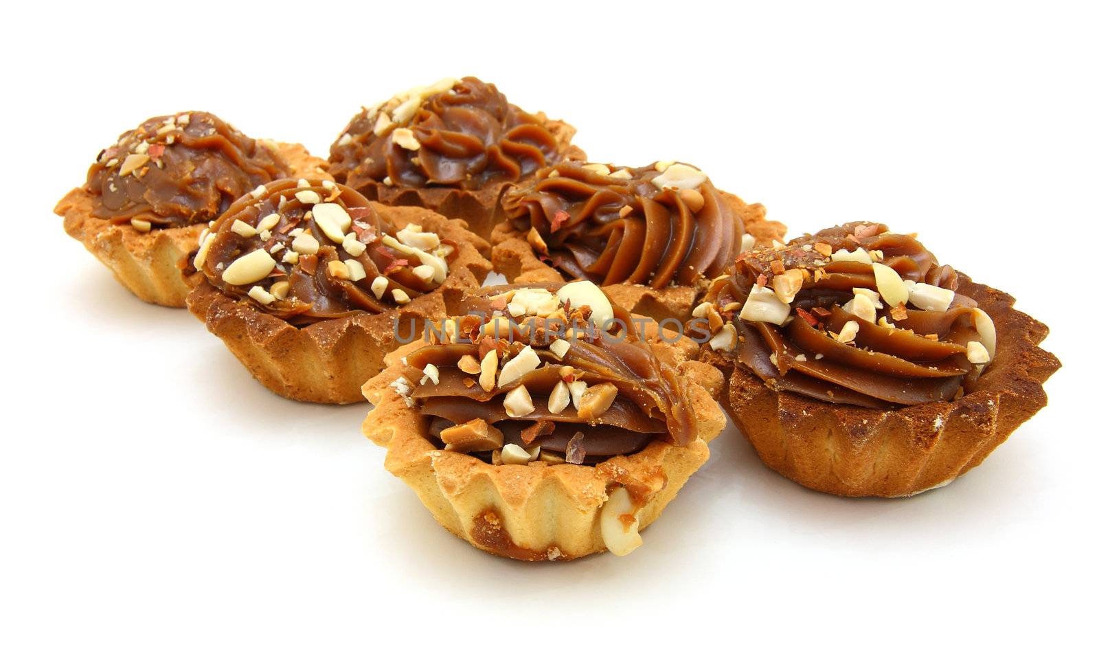 Pie a basket with chocolate condensed milk and nuts on a white background