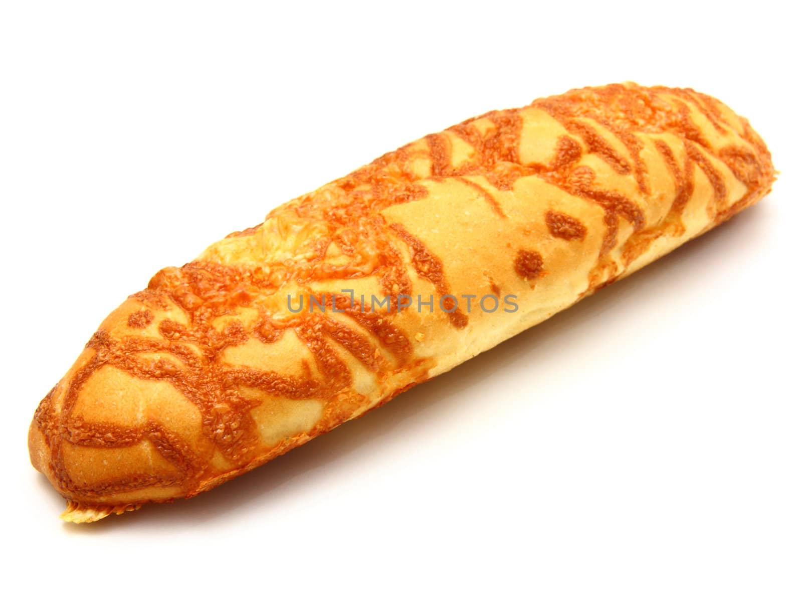 The ruddy long loaf of bread is strewed by cheese isolated on a white background