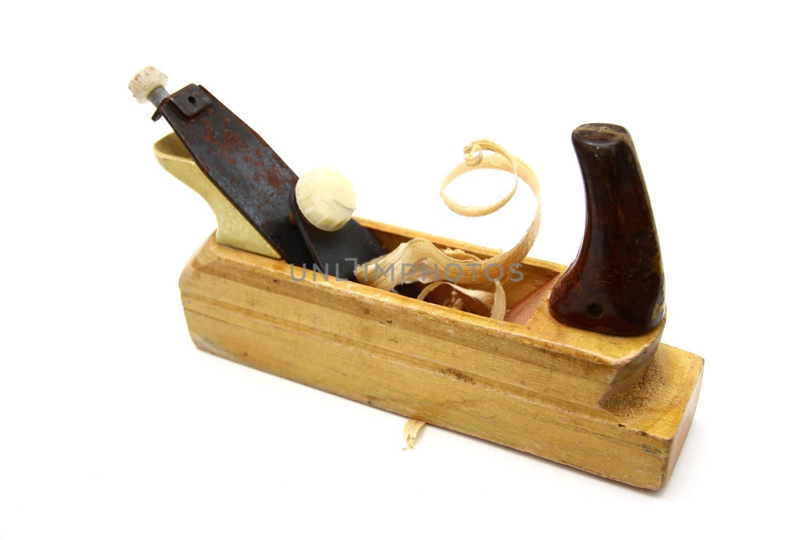 Wooden plane, boards and a shaving on a white background