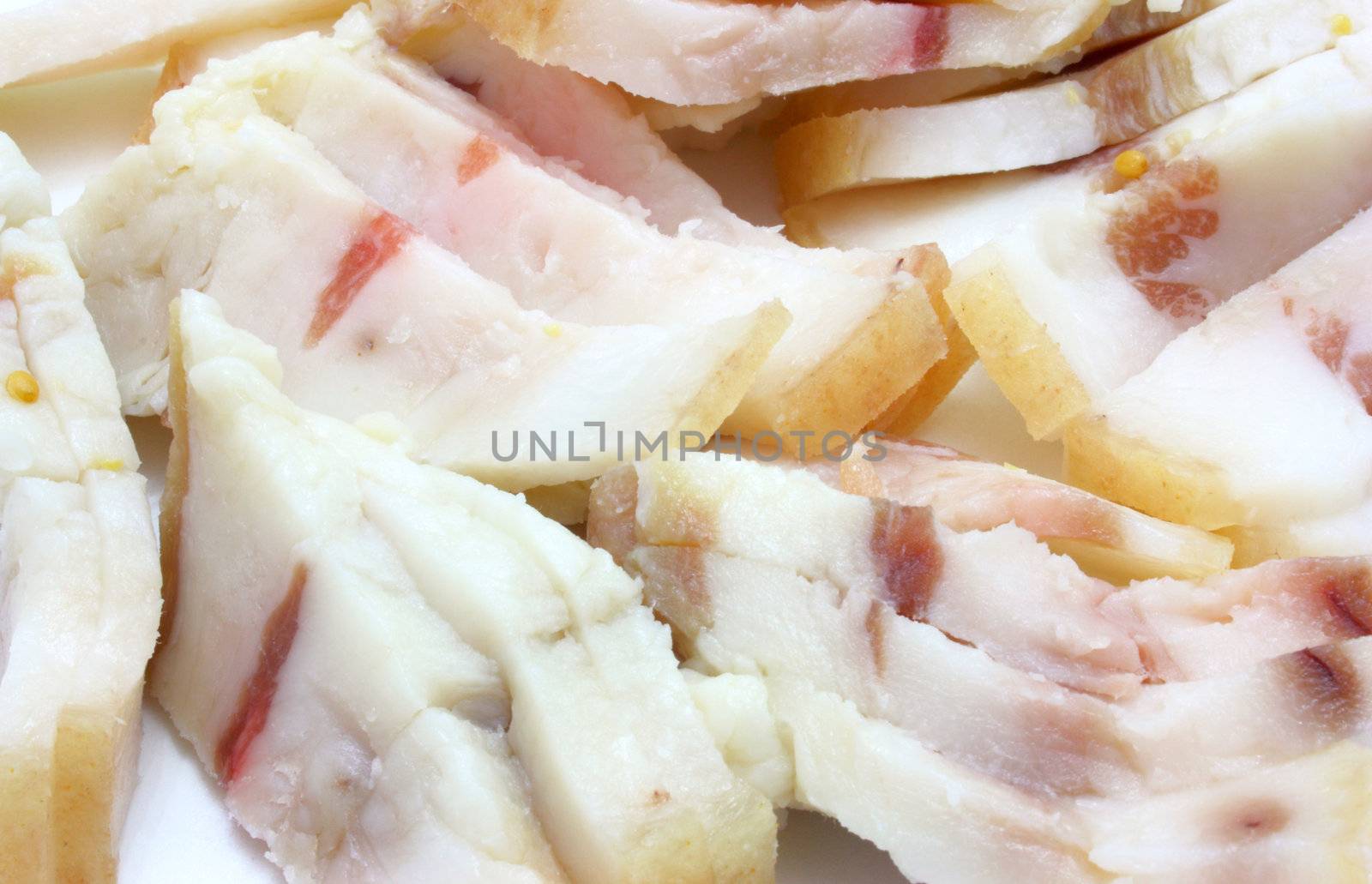 The cut fresh fat with layers lies on a white background