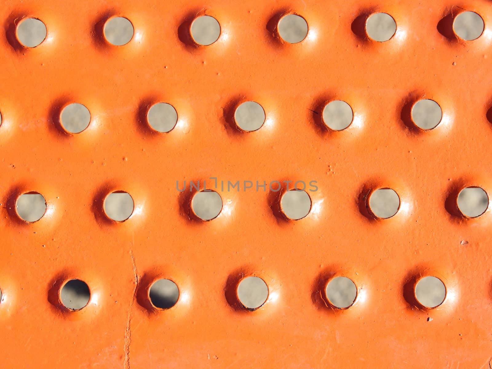 industrial grunge background of sunburst metal rivets