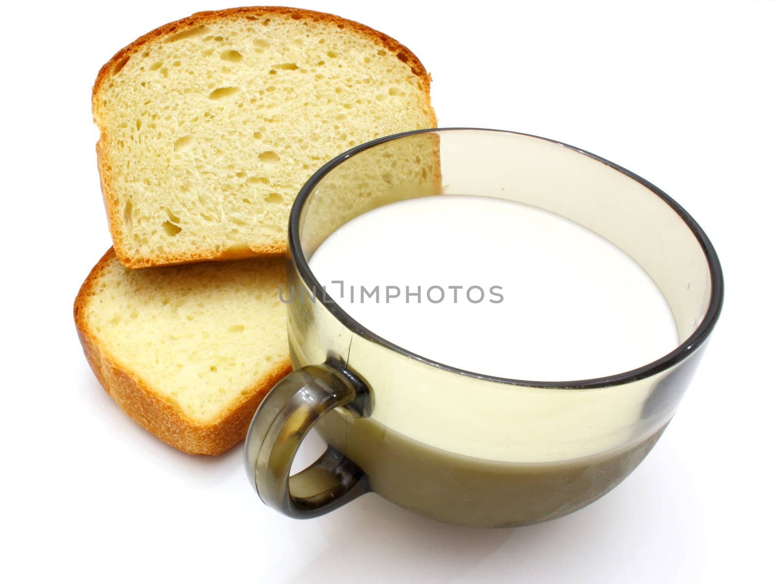 Black bread with milk in a mug on the white isolated background