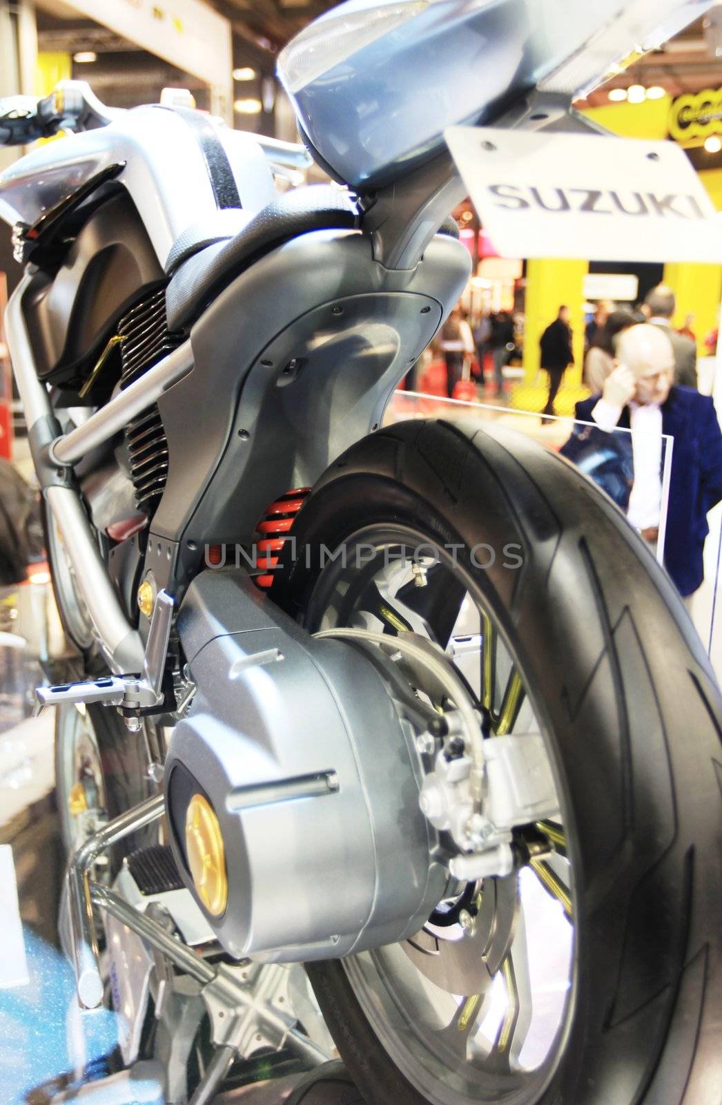 Looking at Suzuki motorcycles in exhibition at EICMA, International Motorcycle Exhibition in Milan, Italy.