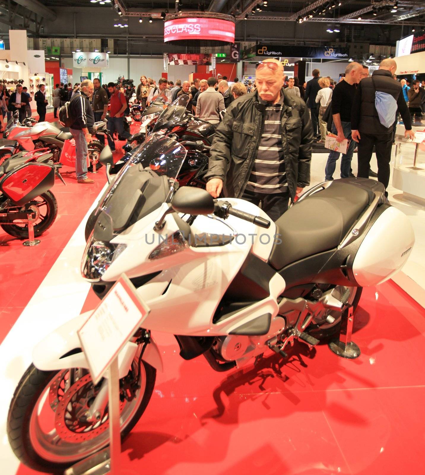 People trough Honda motorcycles exhibition area at EICMA, International Motorcycle Exhibition in Milan, Italy.