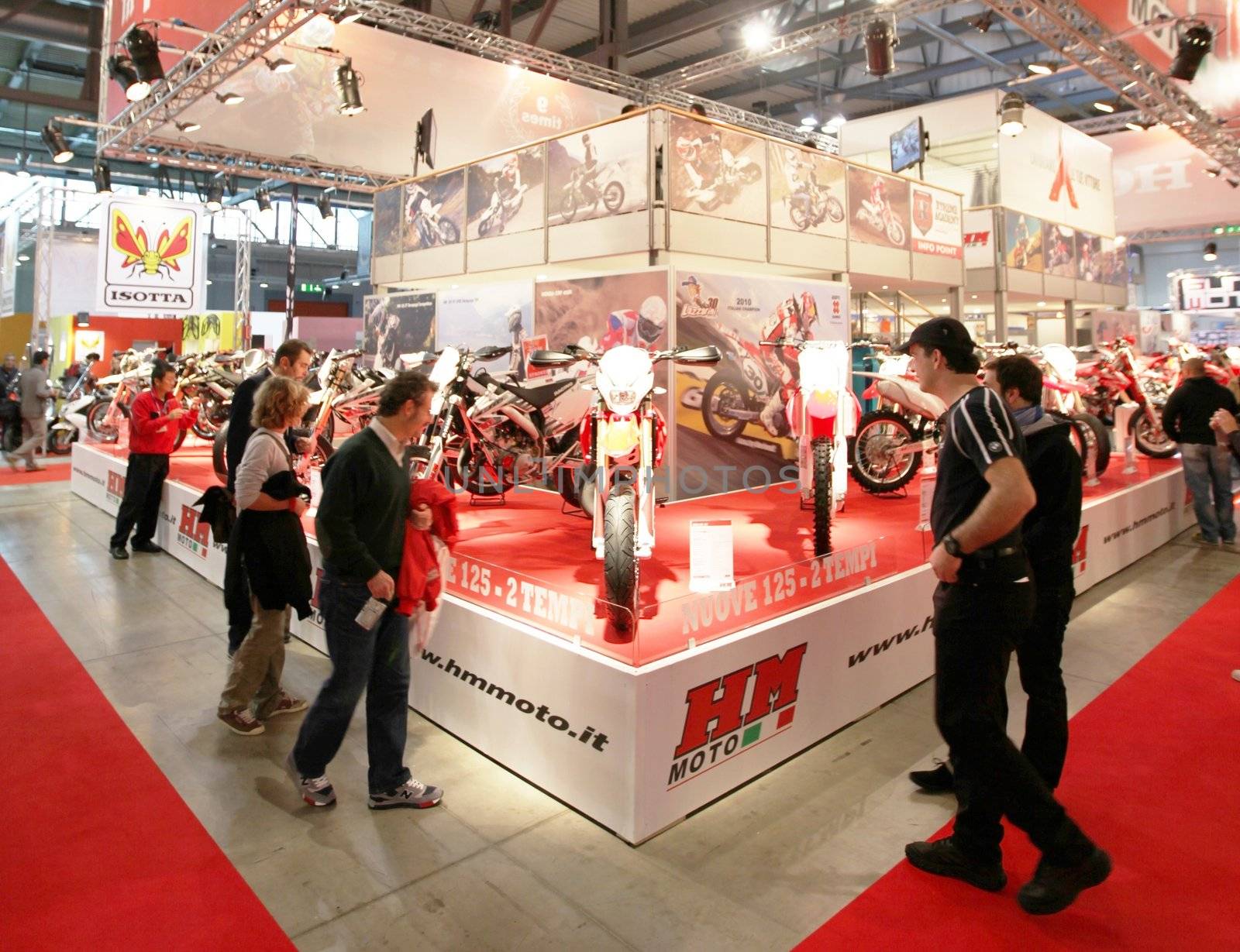 Looking at products and brand new motorcycles during EICMA, International Motorcycle Exhibition in Milan, Italy.