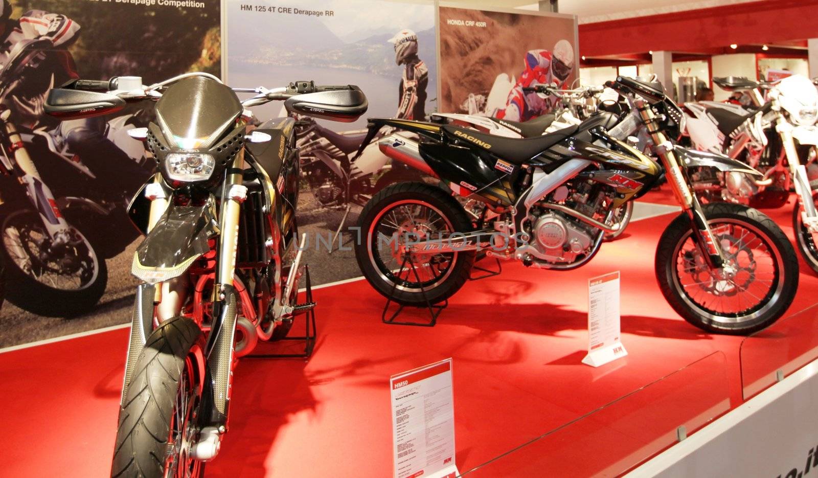 Looking at products and brand new motorcycles during EICMA, International Motorcycle Exhibition in Milan, Italy.