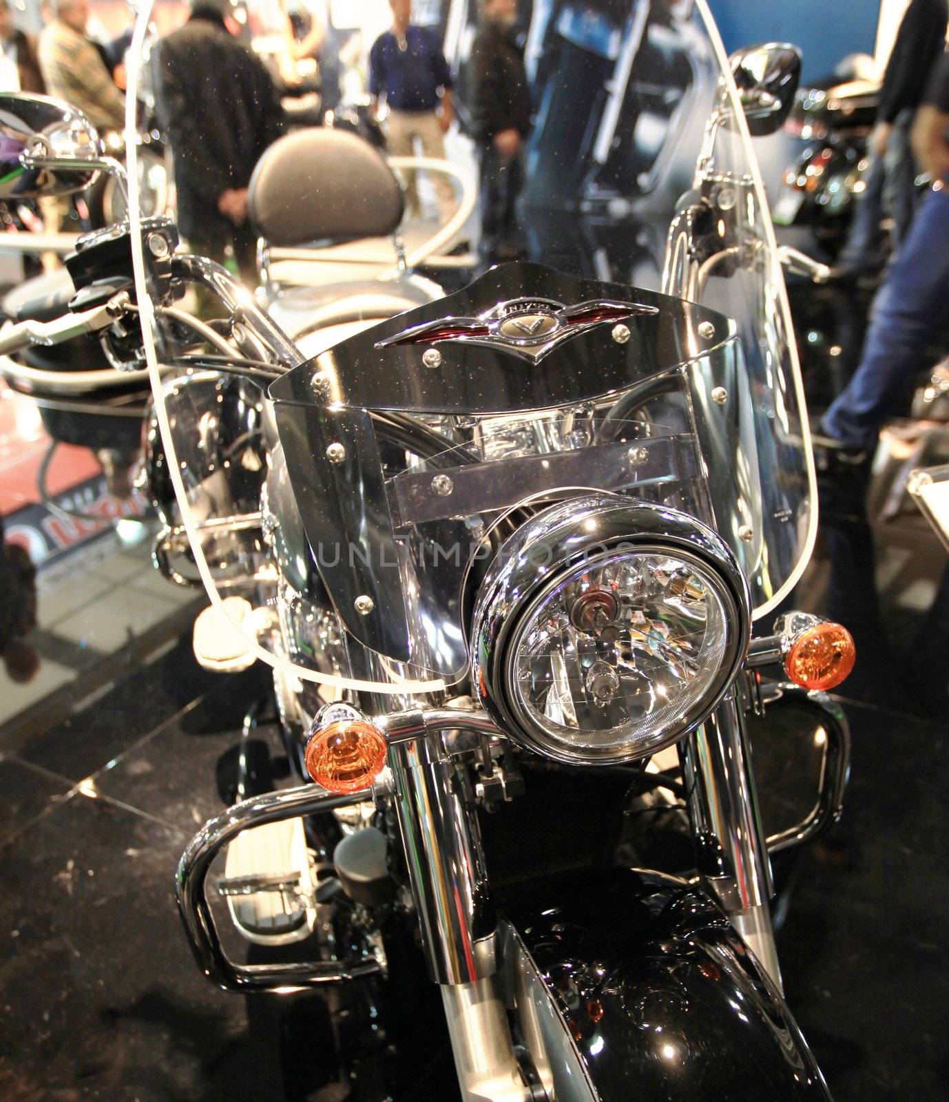 Walking trough scooters exhibition area at EICMA, International Motorcycle Exhibition in Milan, Italy.