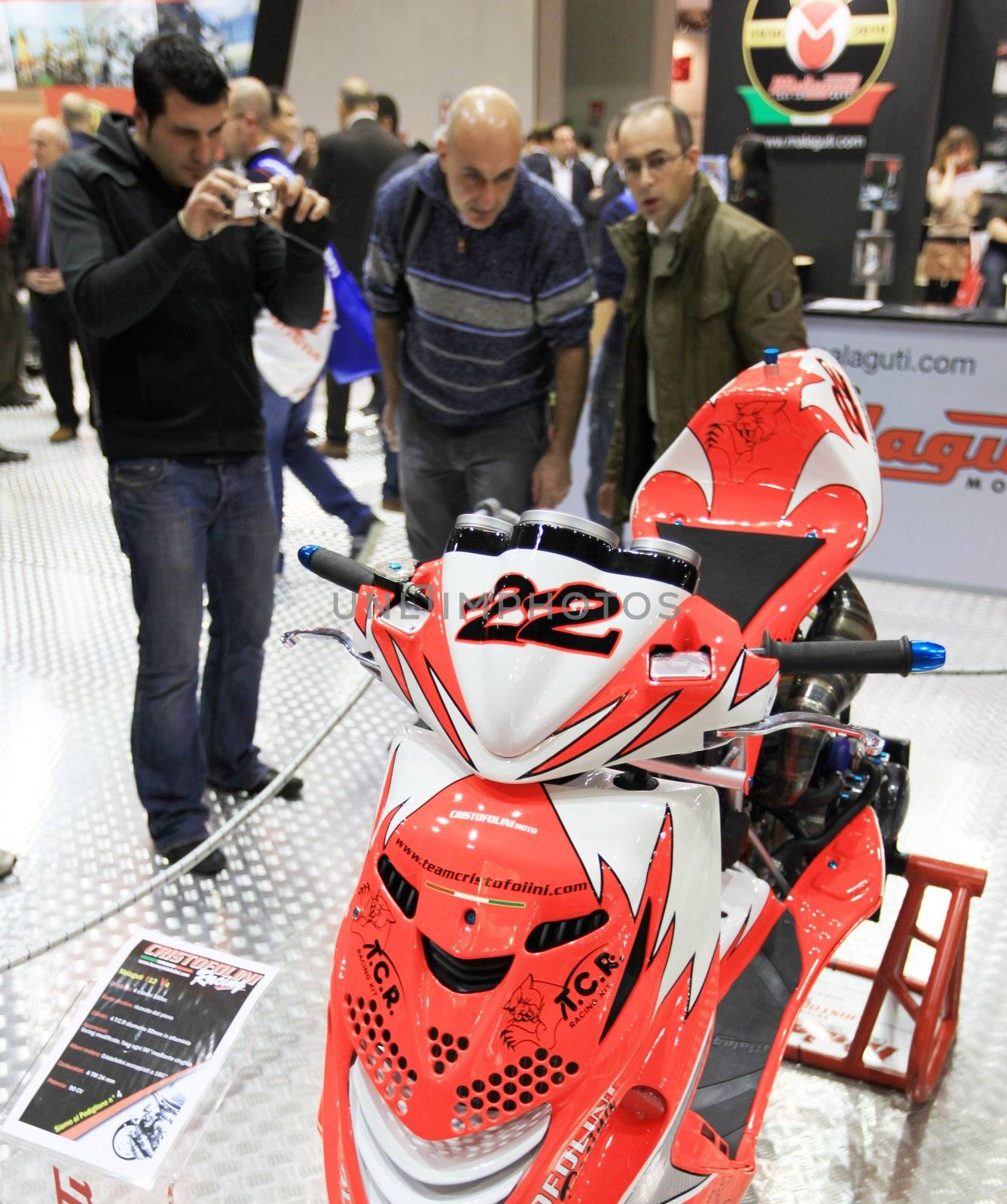 Walking trough scooters exhibition area at EICMA, International Motorcycle Exhibition in Milan, Italy.