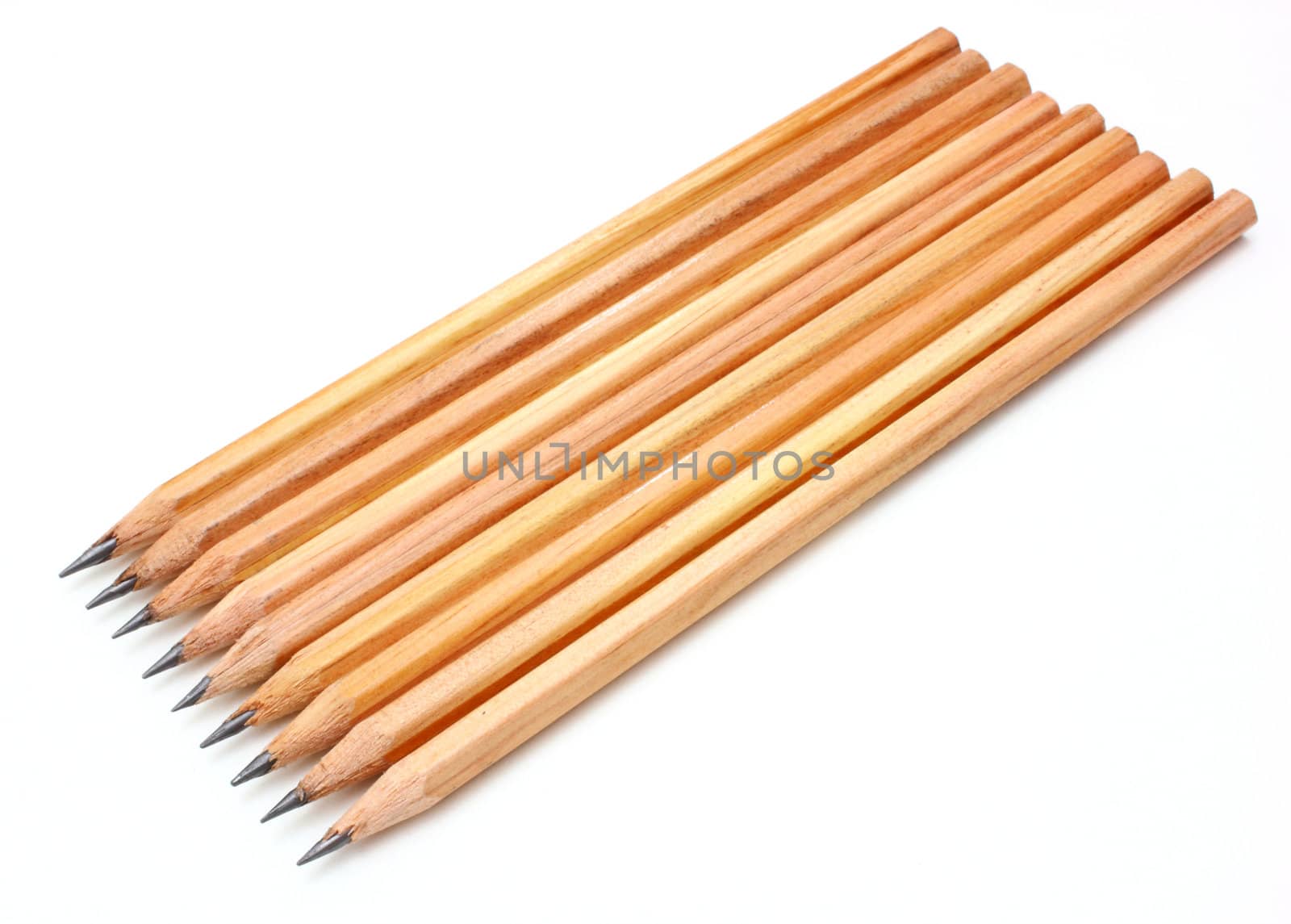 The yellow ground pencil lies is isolated on a snow-white background