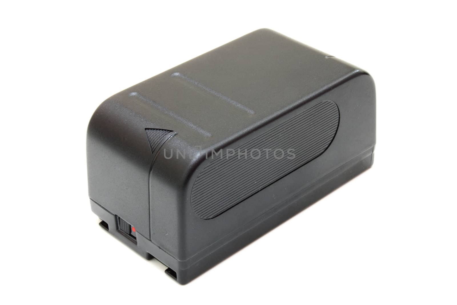 The black small rectangular accumulator from a videocamera on a white background