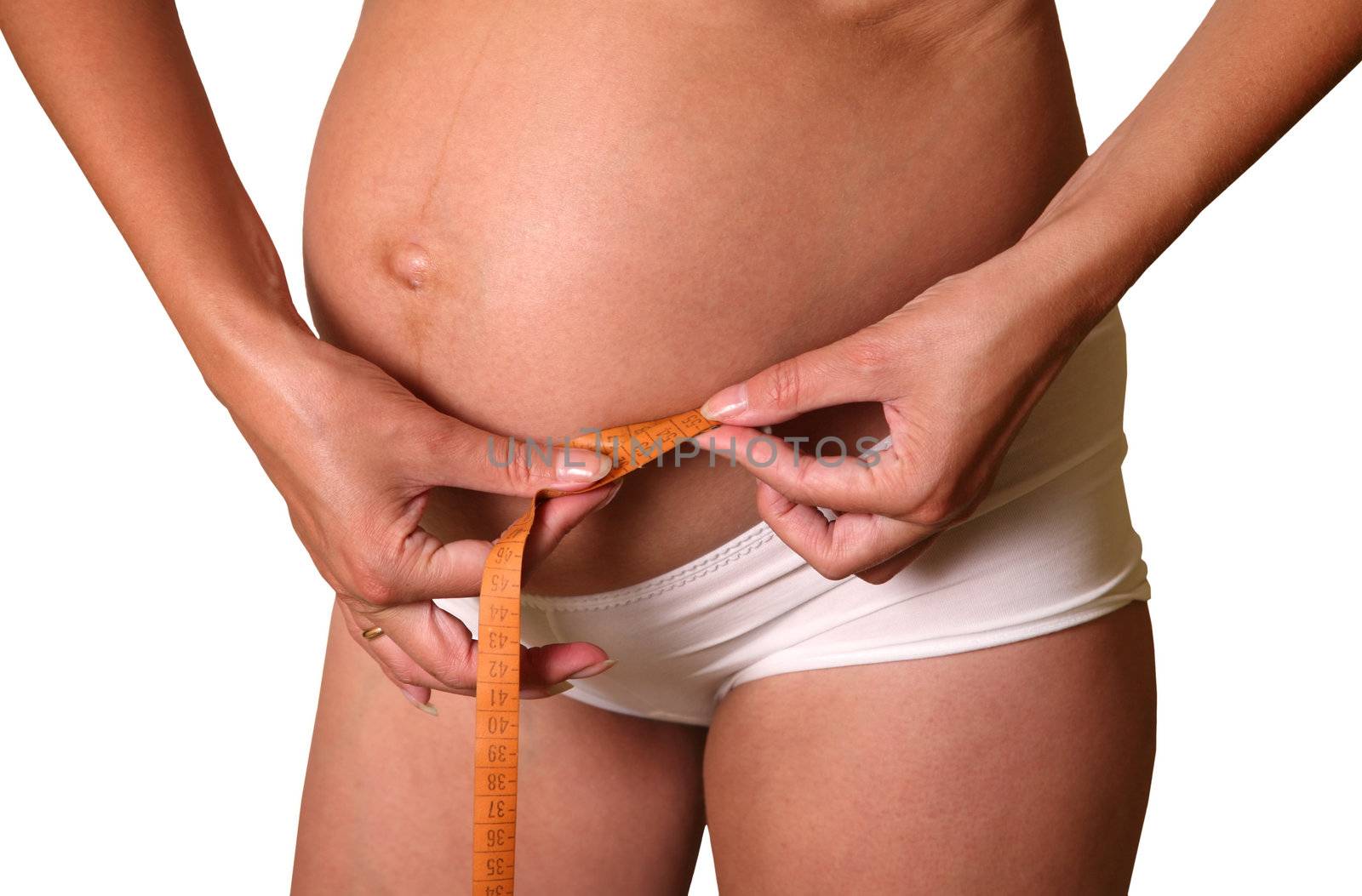 Pregnant woman measuring her a stomach