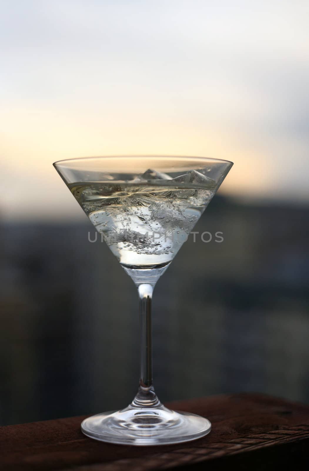 The image of a glass filled with a spirits drink and ice 