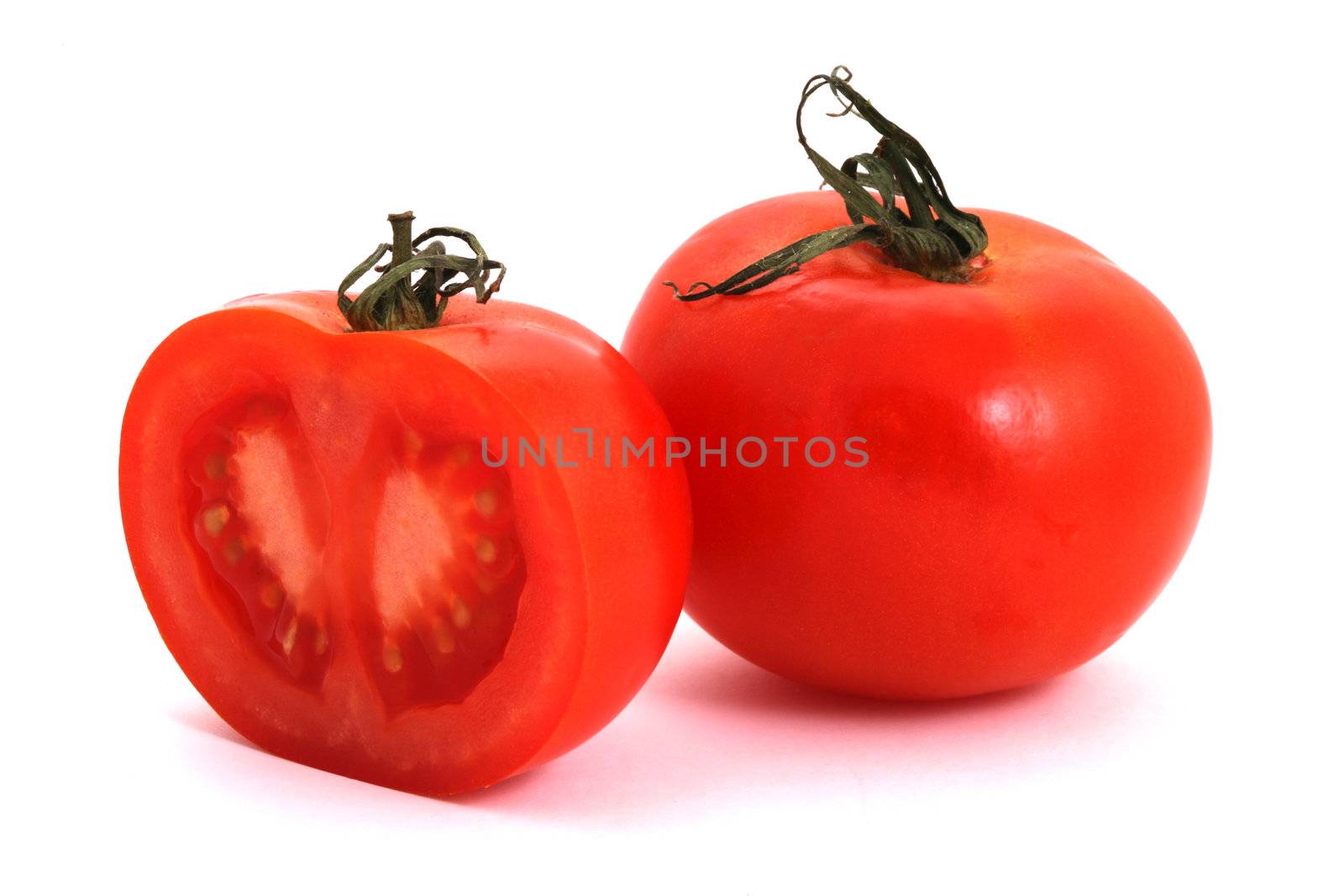 Tomato and half of tomato on a white background