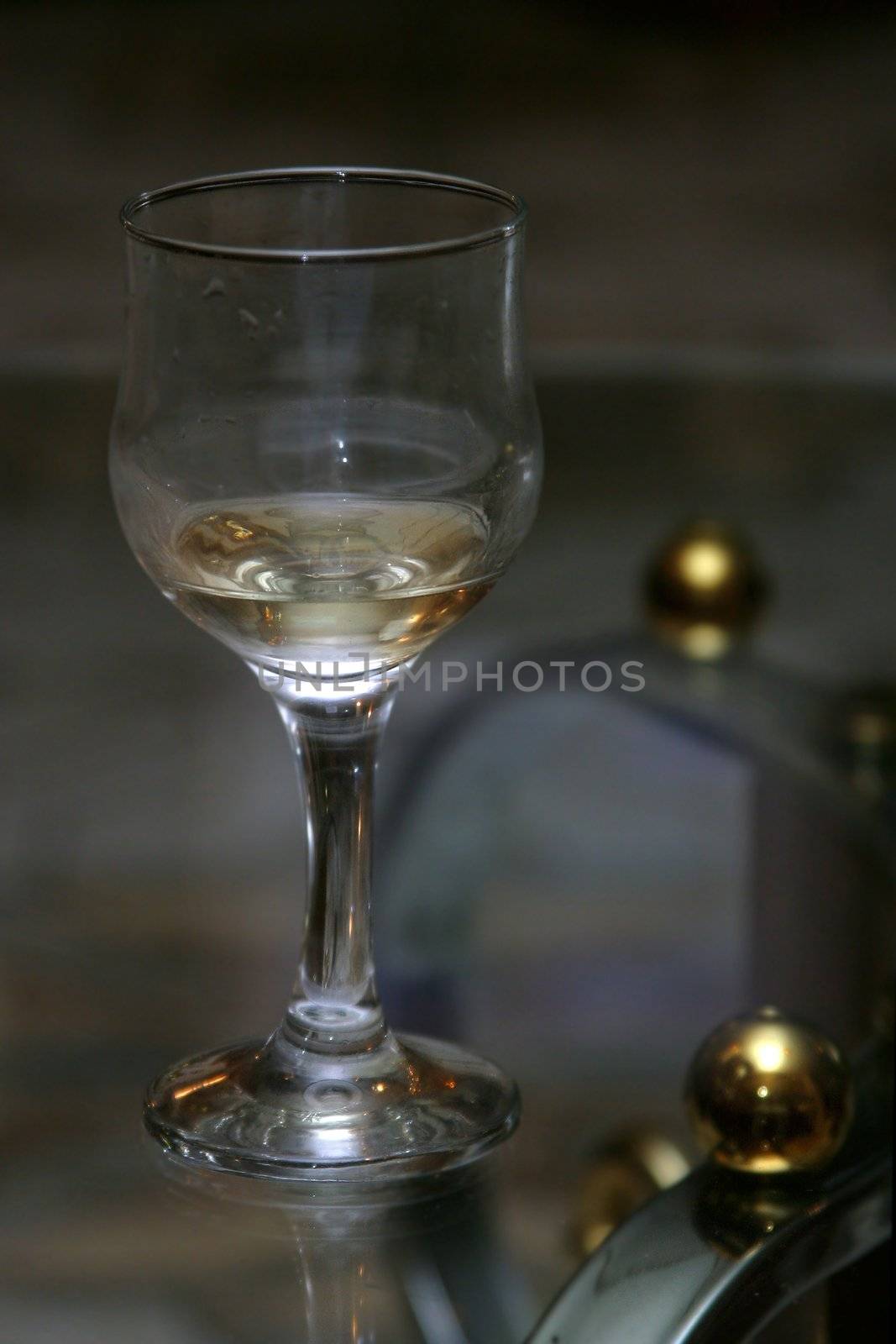 Wine glass with a wine on a transparent table